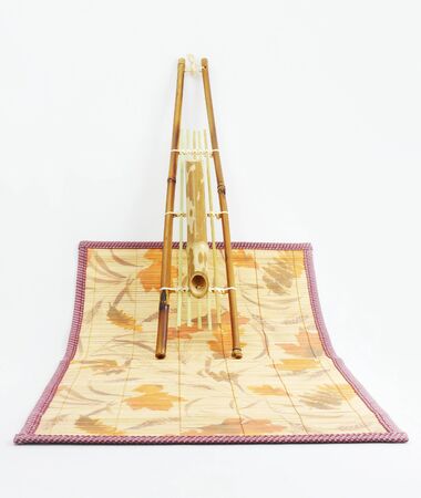 Hanging bamboo basket of flowers isolated の写真素材