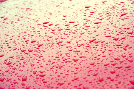 Depth of Field water drops on red glass.の写真素材