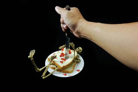 Human skeleton sanwich dinner halloween night on black background.の写真素材