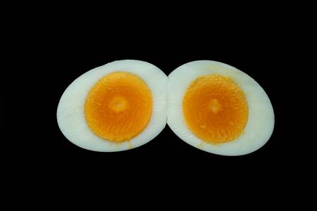 Boiled sliced chicken eggs isolated on Blackの写真素材