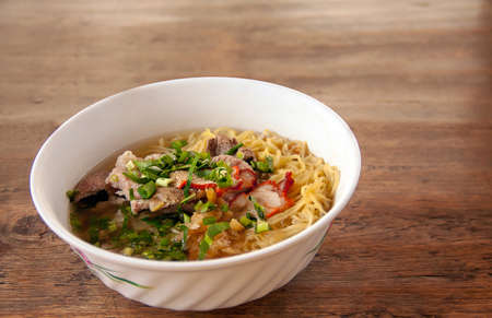 Noodle soup with red pork and Pig liver On top celery Onion pepper noodles Traditional Thai Street...