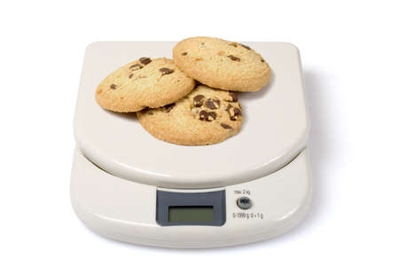 Scale with cookies isolated over a white background. Check other photos in the serie.の写真素材
