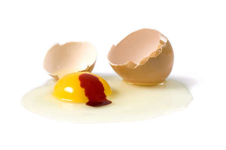 Broken and bleeding egg isolated over a white backgroundの写真素材