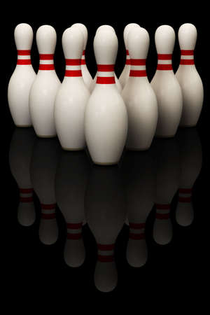 Bowling pins isolated over a black background. This is a 3D rendered picture.の写真素材