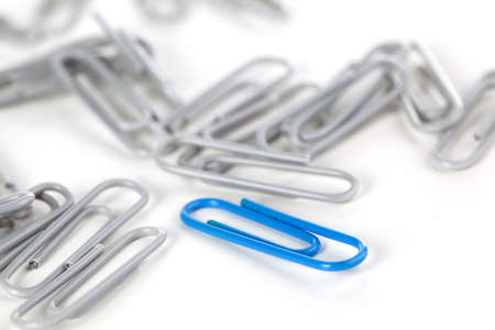 Close-up on paper-clips isolated over a white background. Shallow depth of field.の写真素材