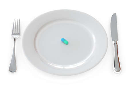 Pill in a plate isolated over a white background.の写真素材