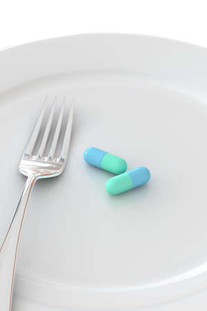Pill in a plate isolated over a white background.の写真素材