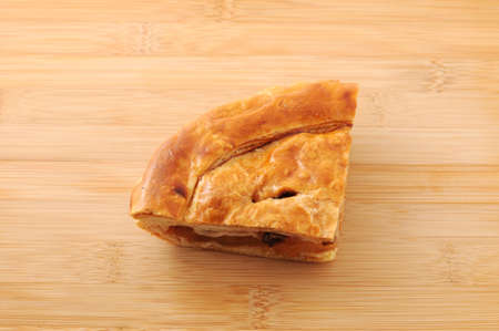 Slice of delicious fresh baked Rustic Apple Pie isolated on cutting boardの写真素材