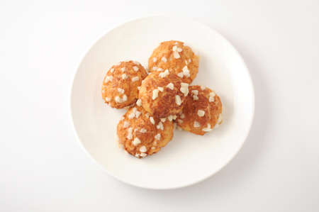 chouquette cream puff on plate on white background