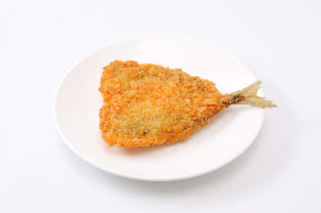 fried fish sardine on a plate on white backgroundの写真素材