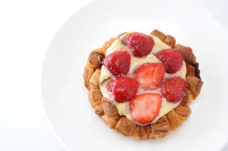 strawberry cake with custard cream on a plate on white background