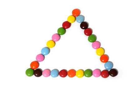 triangle of colorful chocolate candy spread on white background