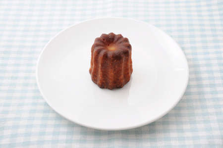 canele de Bordeaux french pastry on plate on table clothの写真素材