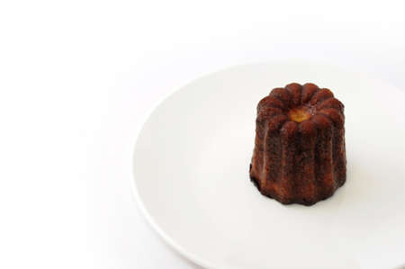 canele de Bordeaux french pastry on plate isolated on white backgroundの写真素材