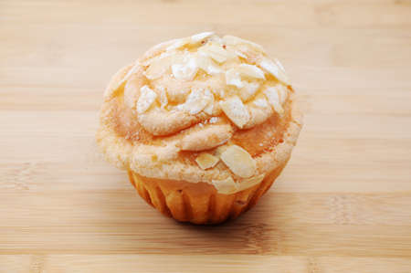 cup cake muffin with almond and suggar on cutting board