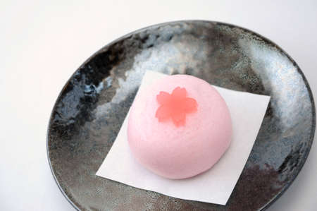 a Japanese traditional  confectionery cake wagashi on plate on white backgroundの写真素材