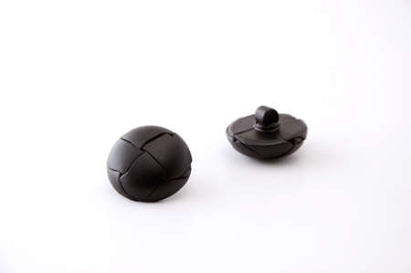 2 pieces of black leather buttons isolated on white background