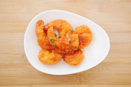 stir-fried shrimp in chili sauce Chinese dish on plate on tableの写真素材