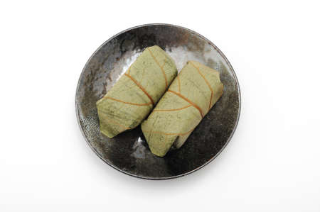 Salmon kakinoha sushi on plate on white backgroundの写真素材