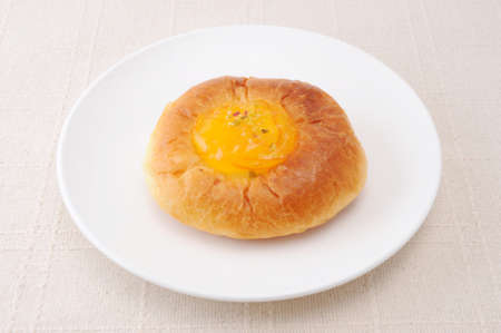 orange marmalade bread on plate on table cloth