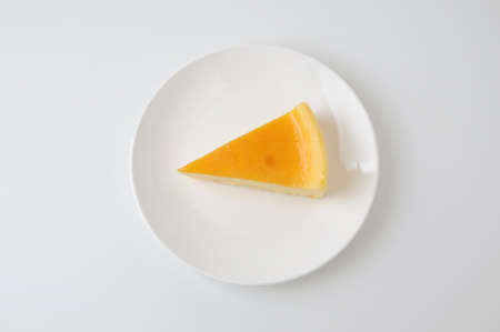 piece of fresh cheese cake on plate isolated on white background