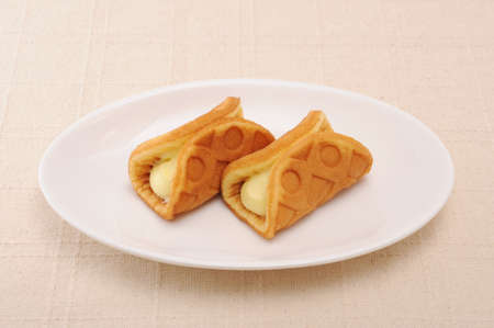 waffle custard cream roll on plate on table
