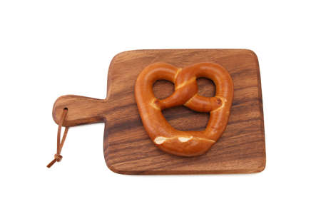 pretzel German bread on wood plate isolated on white background