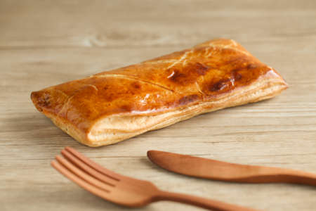 meat pie with fork knife isolated on tableの写真素材