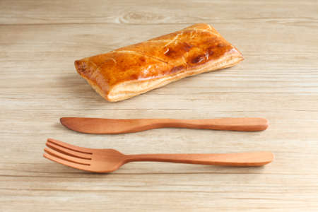 meat pie with fork knife isolated on table