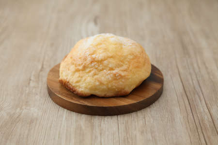 sugar bread melon pan on wood plate isolated on table