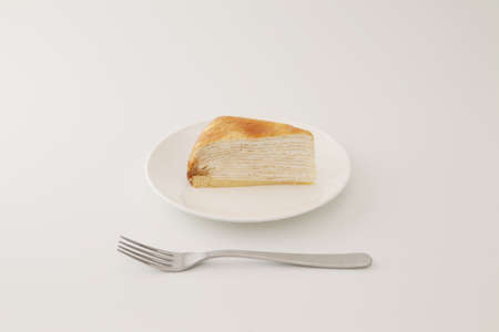 Mille crepe french cake on a plate on white background