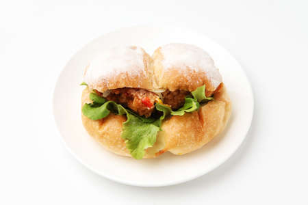 fried chicken hamburger lettuce on plate isolated on white backgroundの写真素材