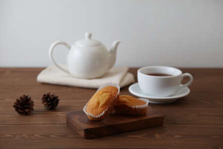 cup cakes on wooden table with tea pot cup