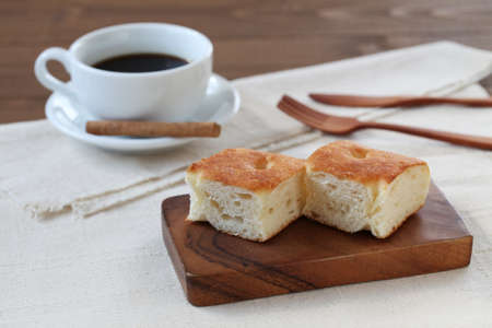 focaccia pizza bread on wooden table with cup of coffee
