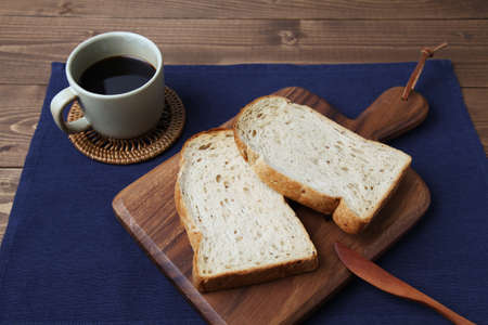 toasted slices of Bread with walnuts on wooden cutting board on table