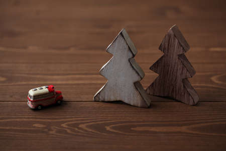 wooden trees with a miniature car isolated on tableの写真素材