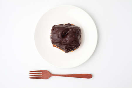 chocolate croissant bread danish on plate on white backgroundの写真素材