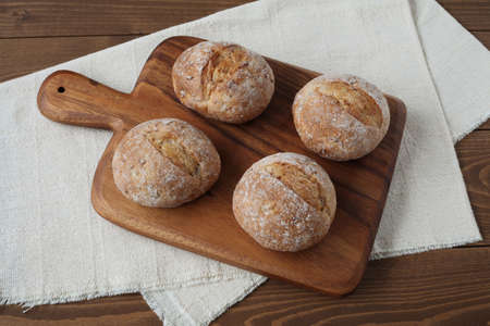 french rye bread  on cutting board isolated on wooden table
