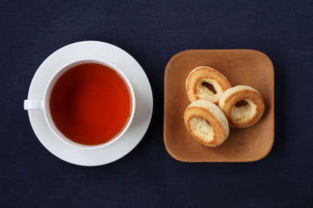 ring scone biscuit on plate with hot tea isolated on tableの写真素材