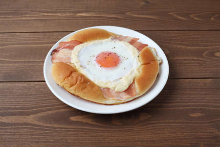 bacon egg bread on plate closeup isolated on table