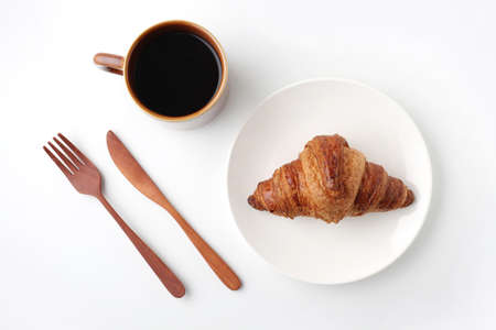 croissant french bread on plate and hot coffee closeup isolated on white background