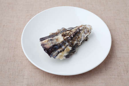 boiled oyster on plate closeup isolated on table clothの写真素材