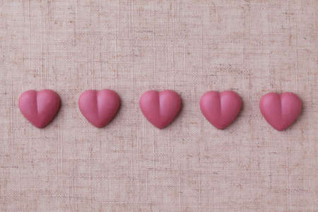heart shaped pink ruby chocolate closeup isolated on table cloth