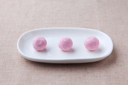 snowball cookies on plate closeup isolated on table cloth