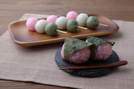 sakura mochi and dango 3 colored dumpling rice cake on plate isolated on table cloth