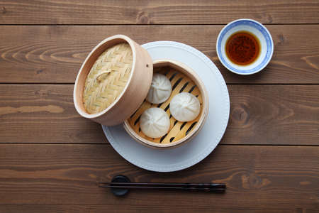 xiaolongbao Chinese steamed bun mantou dumpling on wooden tableの写真素材