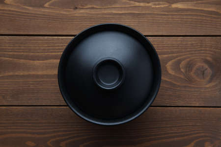 donburi rice bowl black isolated on wooden tableの写真素材