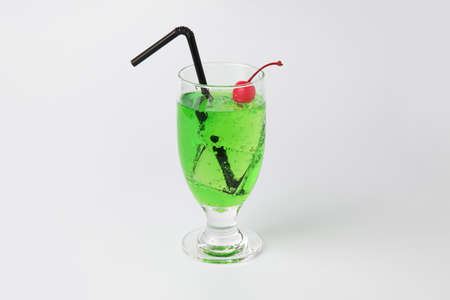 glass of cold melon soda drink isolated on white backgroundの写真素材