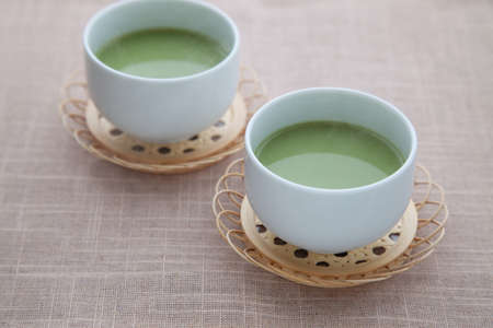 hot green tea with milk matcha latte isolated on table