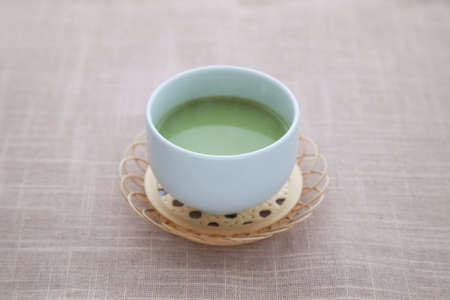 hot green tea with milk matcha latte isolated on tableの写真素材